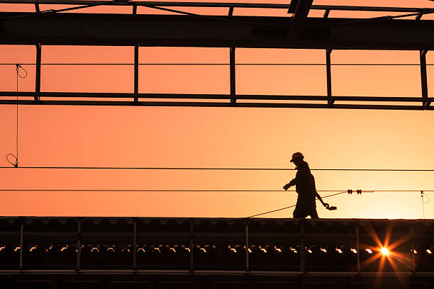 Worker With Hardhat On Building Roof